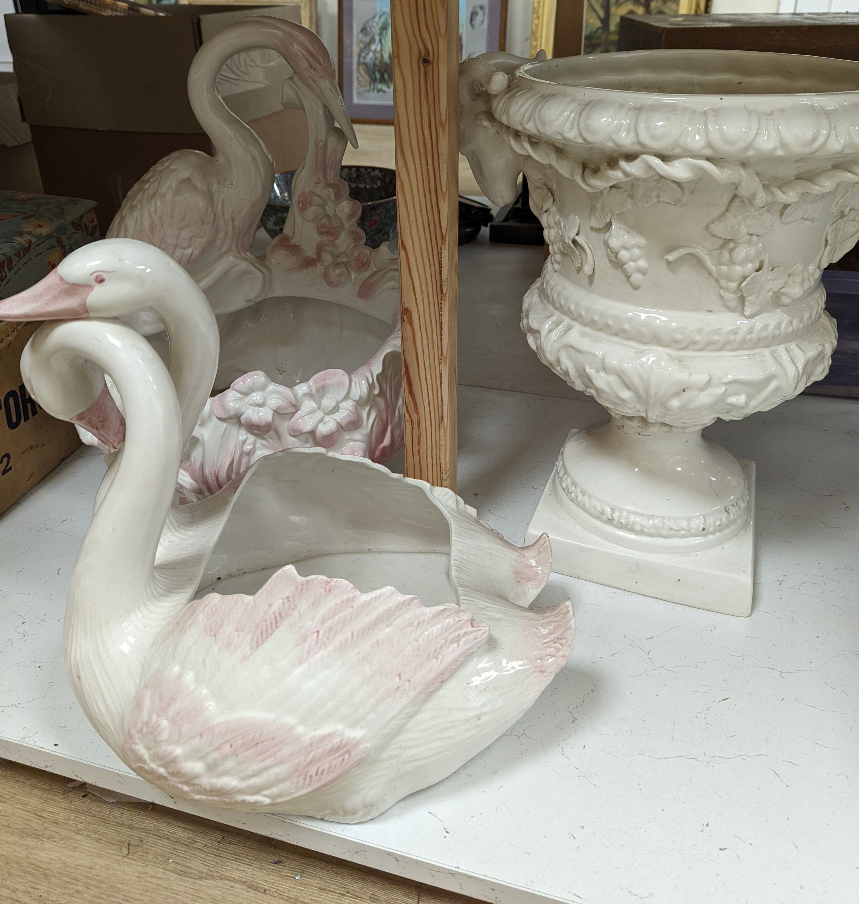 Decorative modern continental pottery, including two jardinières, modelled with swans, a white glazed urn